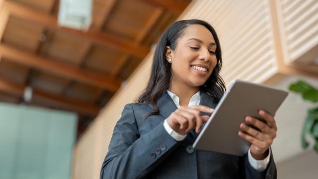 Businesswoman looks at tablet