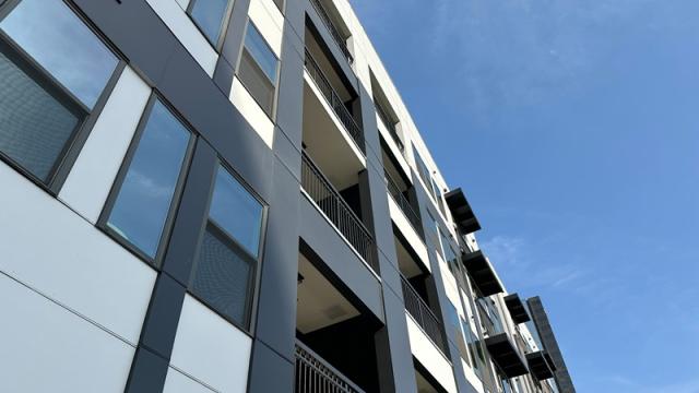 Apartment building exterior against blue sky