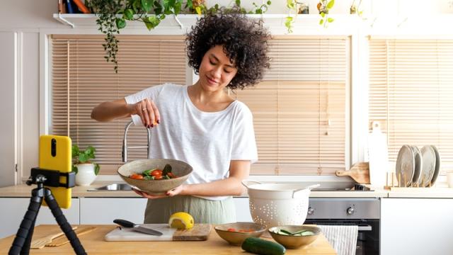 Influencer cooking in apartment kitchen